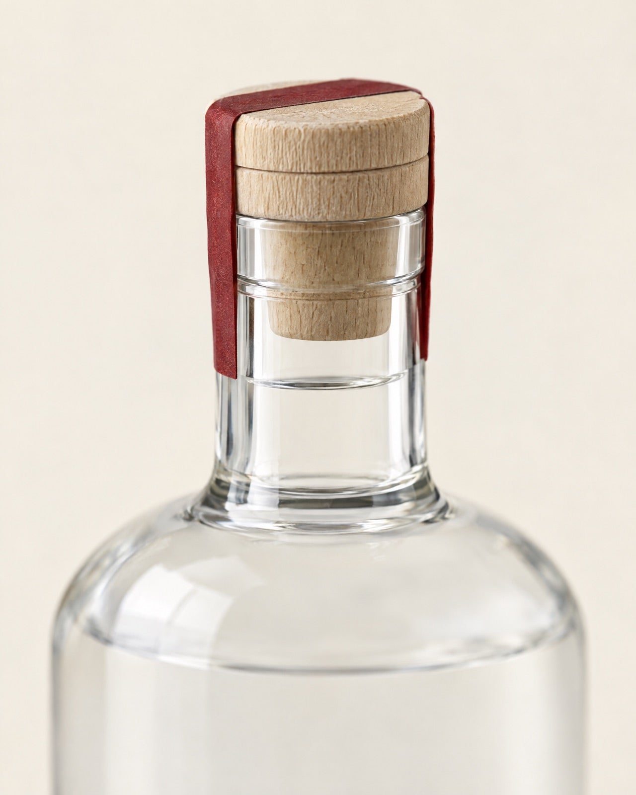 The wooden cork and the seal over the top of the bottle