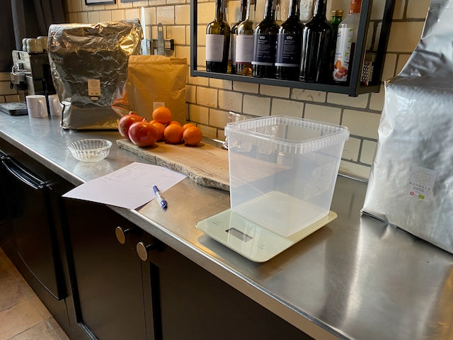 Botanicals being weighed on a steel workbench