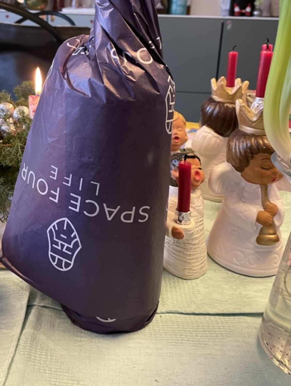 A bottle of Fenrir gin wrapped in blue tissue paper, ready to give
